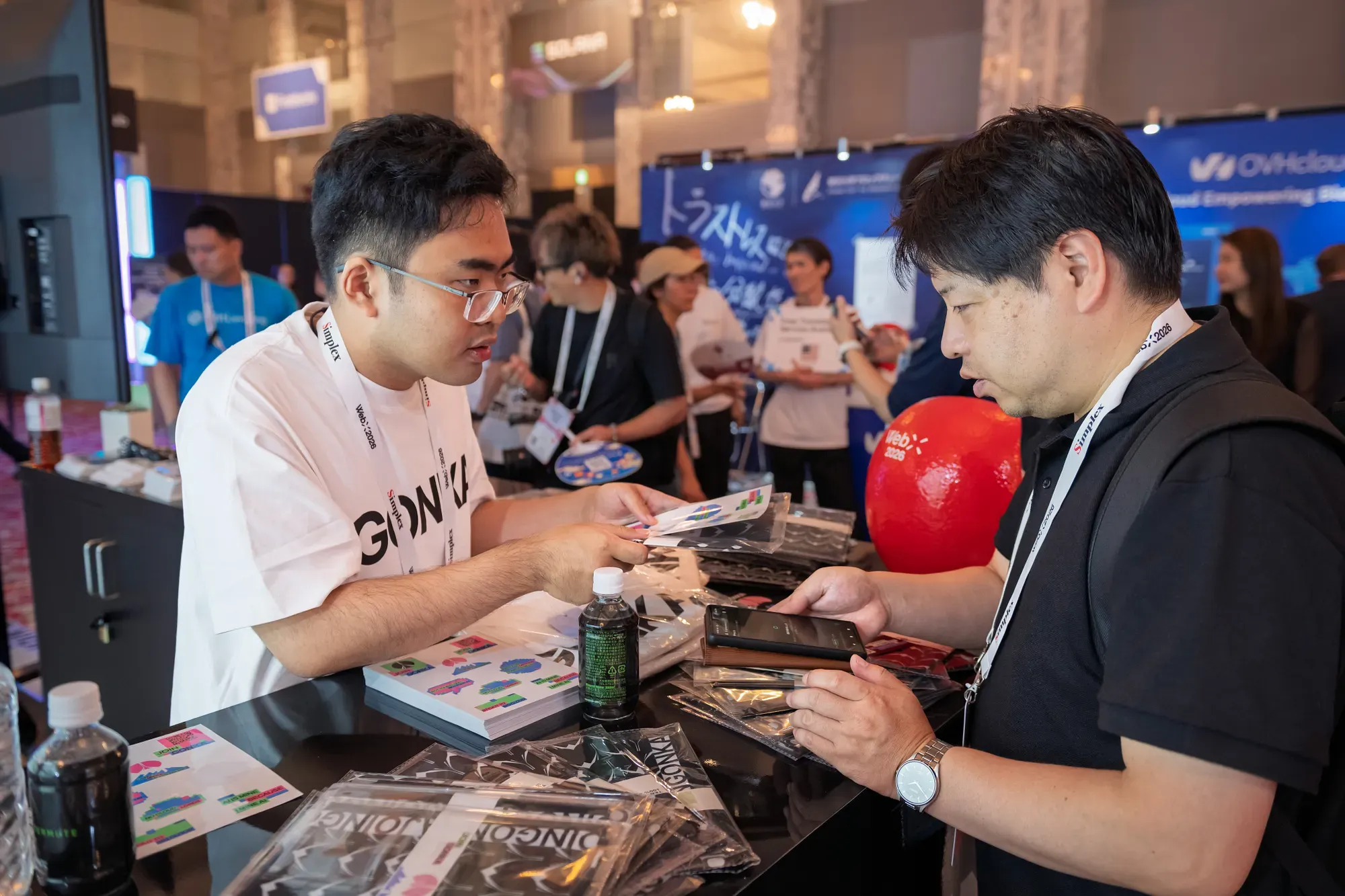 Talking with visitors at the Gonka booth